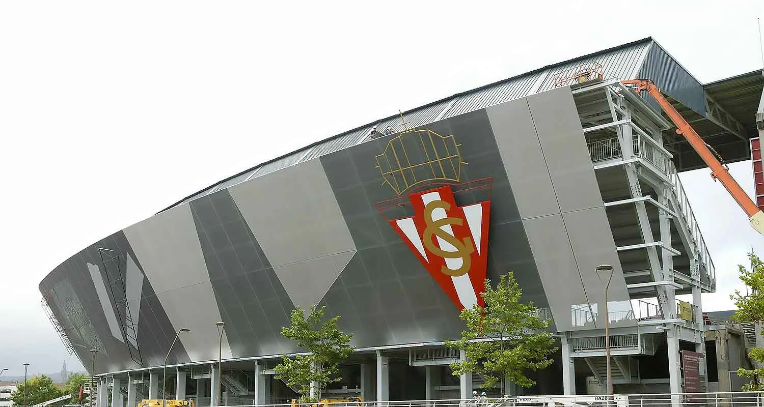 | Las Vegas Awning and StructuresA modern stadium with sleek gray panels and a large red emblem on the facade. Trees and a crane are visible, indicating ongoing work. The design offers sun protection, resembling the innovative Las Vegas awnings used for shade solutions.